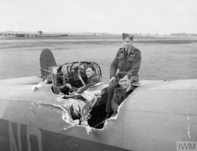 A Handley Page Halifax bomber, seen on the ground, after the bomber above it dropped bombs onto it, a terrifying and usually fatal accident. These men were very lucky. Though it looks bad, this plane was repaired, and continued to fight through the end of the war.