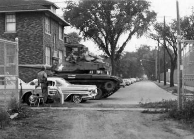 A Walker Bulldog tank patrols riot-stricken neighborhoods in Detroit in 1967.