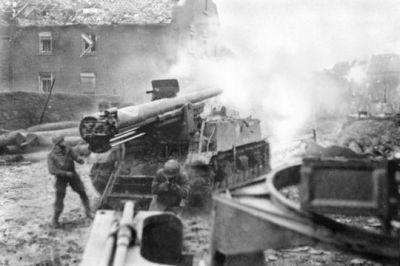 A United States M40/M12 Self-Propelled Gun firing onto a building at point blank in 1945.